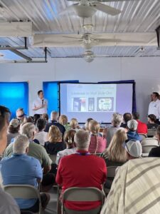 Speaker giving a talk at a conference in front of an audience